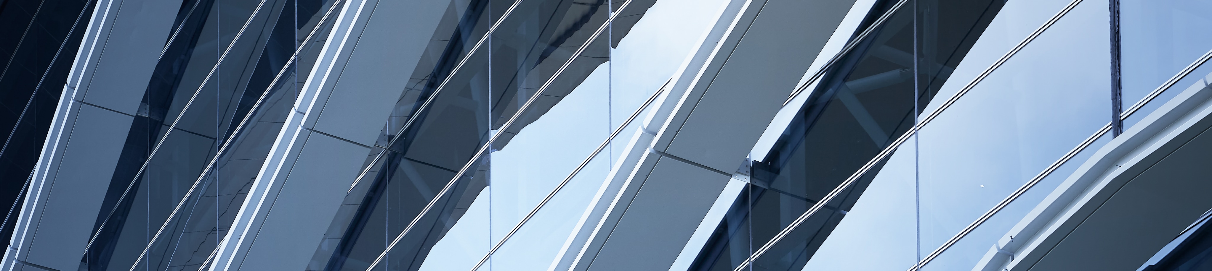 Close up of a windowed surface on a modern but industrial-looking building